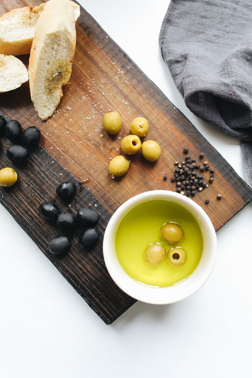 Rustic table setting with organic olives and wine