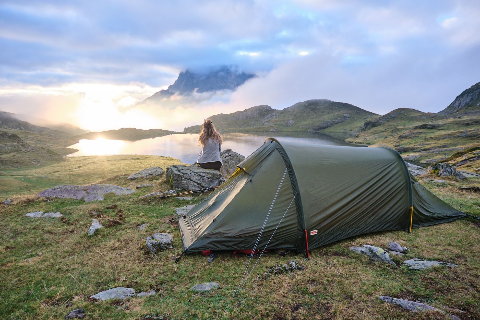 Scenic traveler overlooking tranquil mountain lake